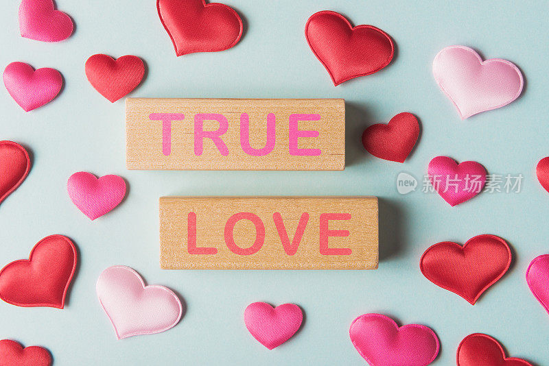 Valentines hearts and wooden blocks with words True Love. Valentineâs day greeting concept